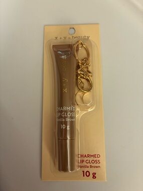 NWT ‘x+y = beauty’ Charmed Lip Gloss in Vanilla Brown. Brand new. Sealed.
